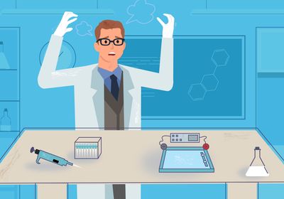 A man with glasses that looks distressed as he stands in front of a laboratory bench with his failed experiment.