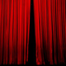 a red stage curtain closing