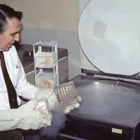 Kurt Benirschke holding a box of frozen vials